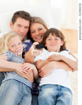 United family watching television sitting on sofa 6196638