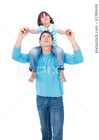 Merry little boy enjoying piggyback ride with his father 6196649