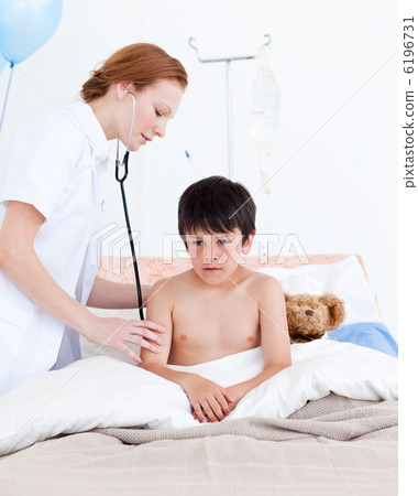 Beautiful doctor examining a little boy 6196731