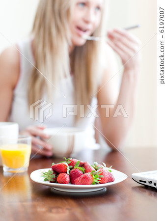 Cute woman having an healthy breakfast Cute woman having an healthy breakfast 6197007