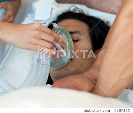 Male patient receiving oxygen mask 6197265