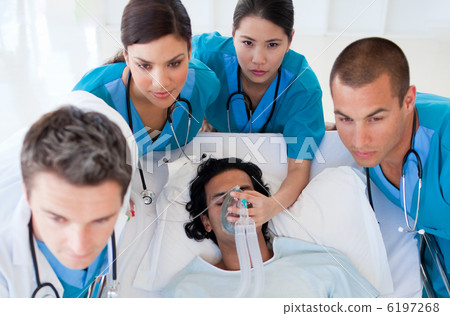 Emergency team carrying a patient 6197268