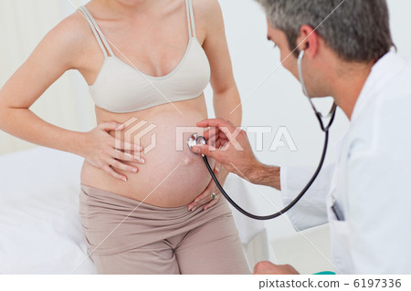 Portrait of a pregnant woman examined by her gynecologist Portrait of a pregnant woman examined by her gynecologist 6197336