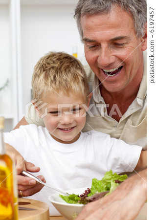 Happy grandfather eating a salad with grandson Happy grandfather eating a salad with grandson 6197457
