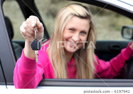 Smiling driver showing a key after bying a new car Smiling driver showing a key after bying a new car 6197942