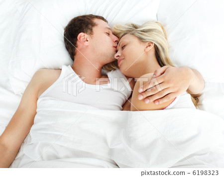 Boyfriend kissing her girlfriend in bed 6198323