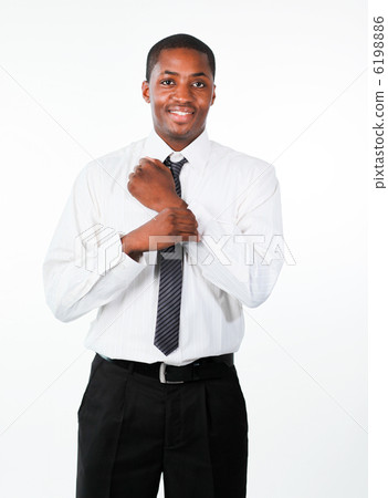 Ethnic businessman corrects a cuff link 6198886