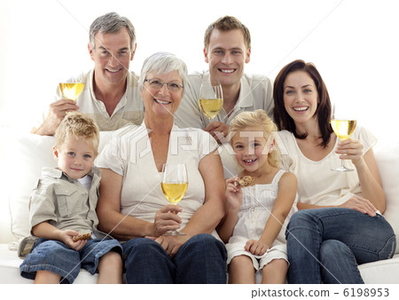 Portrait of family drinking wine and children eating biscuits 6198953