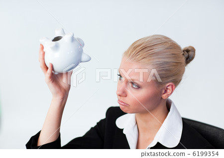 Sad Business woman looking into Piggy Bank Sad Business woman looking into Piggy Bank 6199354