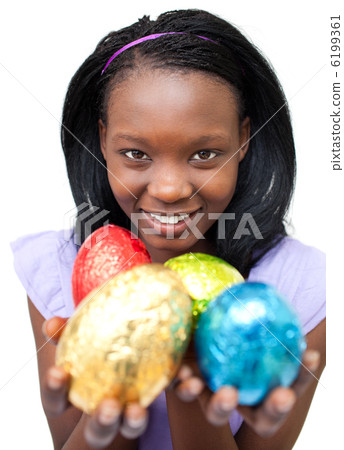 Smiling ethnic woman showing Easter eggs Smiling ethnic woman showing Easter eggs 6199361