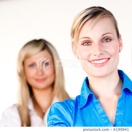 Businesswoman smiling at the camera with her colleague 6199941