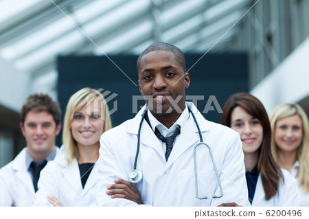 Afro-American doctor leading his team with folded arms Afro-American doctor leading his team with folded arms 6200496
