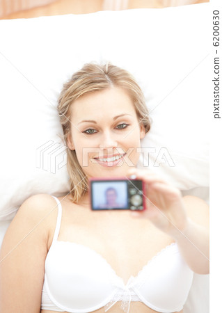 Attractive woman taking a picture of herself 6200630