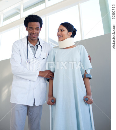 A doctor helping a patient with neck brace and on crutches 6200713
