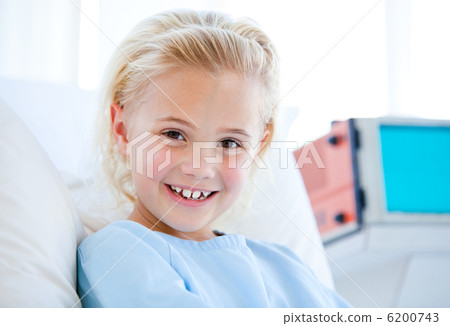 Sick little girl sitting on a hospital bed Sick little girl sitting on a hospital bed 6200743