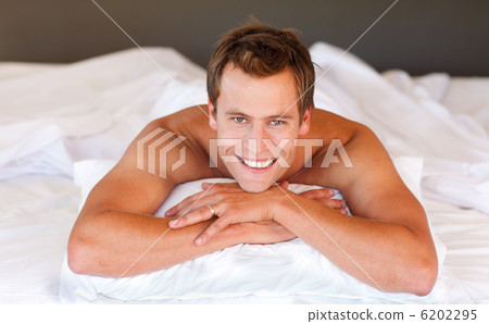 Attractive man smiling on bed Attractive man smiling on bed 6202295