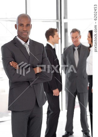 Young Businessman standing out from the Crowd 6202453