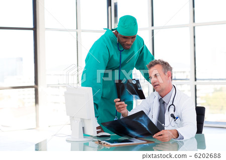Doctors looking at an X-ray Doctors looking at an X-ray 6202688