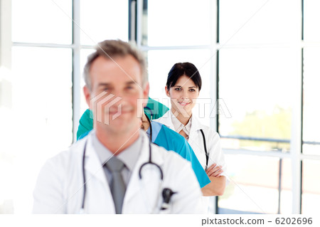 Confident young female doctor smiling at the camera Confident young female doctor smiling at the camera 6202696