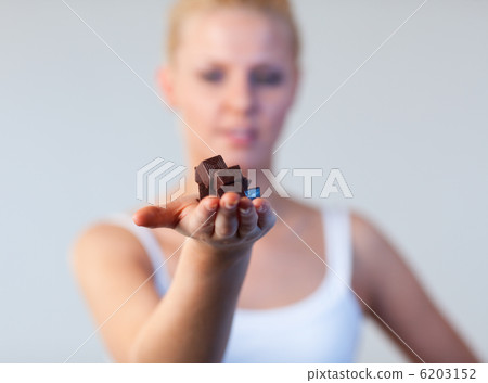 Beautiful woman holding chocolate focus on chocolate Beautiful woman holding chocolate focus on chocolate 6203152