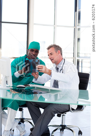 Doctor and surgeon studying an X-ray Doctor and surgeon studying an X-ray 6203174