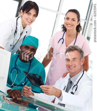 Group of doctors talking in an office Group of doctors talking in an office 6203941