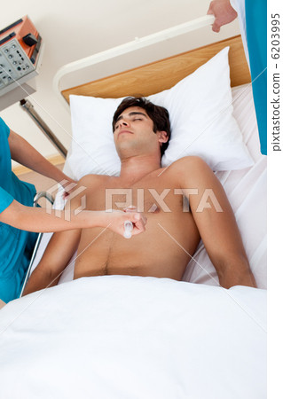 Doctor resuscitating a patient with an injection of adrenalin 6203995