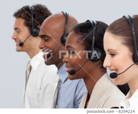 Concentrated business co-workers using headset Concentrated business co-workers using headset 6204224