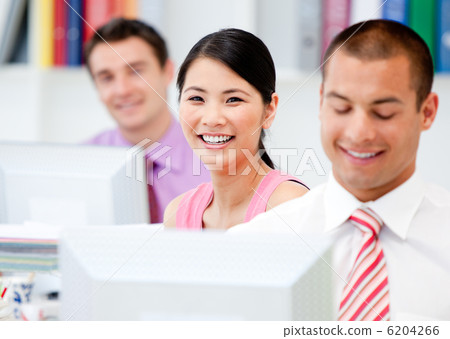 Happy business people working at a computer Happy business people working at a computer 6204266