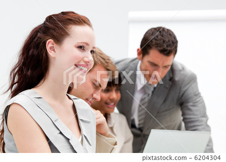Portrait of a smiling businesswoman working with her colleagues Portrait of a smiling businesswoman working with her colleagues 6204304