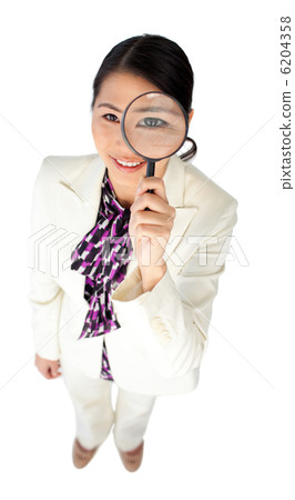 Young Asian businesswoman looking through a magnifying glass 6204358