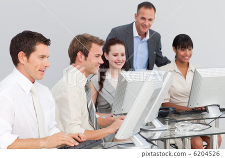 Multi-ethnic business people and manager working with computers Multi-ethnic business people and manager working with computers 6204526