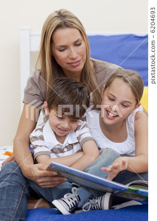 Mother reading a book with her daughter and son Mother reading a book with her daughter and son 6204693