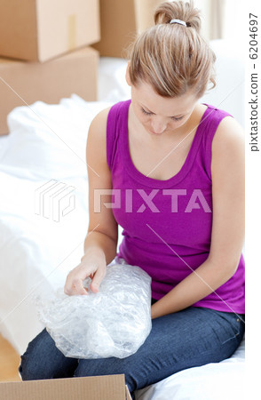 Beautiful woman unpacking box 6204697