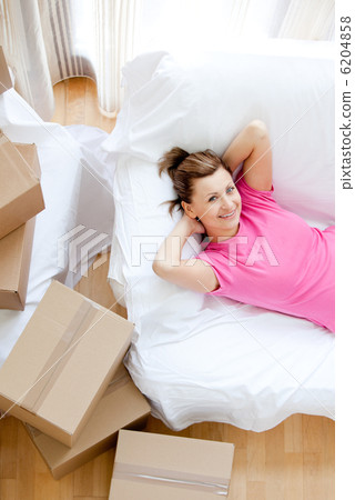 Beautiful woman having a break between boxes Beautiful woman having a break between boxes 6204858