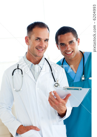 Internatioanl doctors smiling at the camera Internatioanl doctors smiling at the camera 6204993