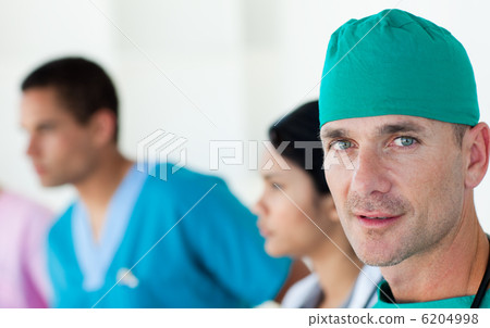 Confident surgeon with his team in the background 6204998