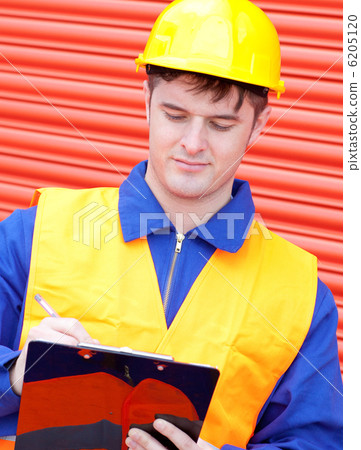 Mature male engineer writing his report Mature male engineer writing his report 6205120