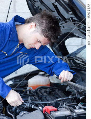 Self-assured man repairing a car Self-assured man repairing a car 6205122