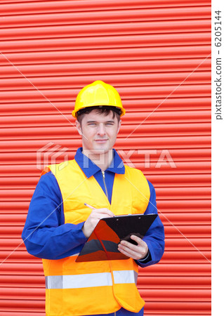Confident male engineer writing his report 6205144