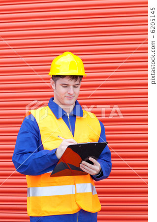 Self-assured male engineer writing his report Self-assured male engineer writing his report 6205145