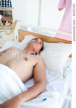 Barechested patient lying on a hospital bed 6205191