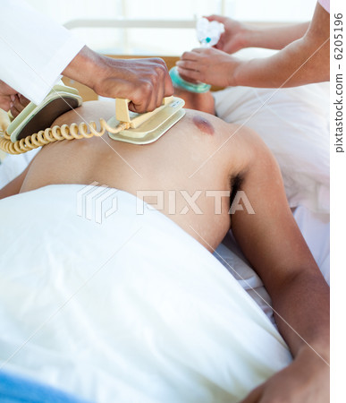 A doctor performing a CPR on a patient 6205196
