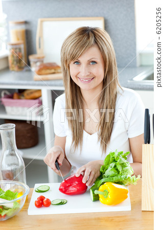 Teen woman preparing a salad in the kitchen Teen woman preparing a salad in the kitchen 6205256
