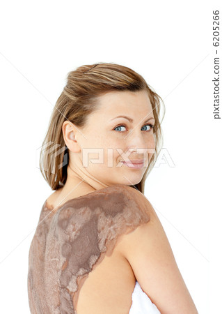 Portrait of a charming woman enjoying a mud skin treatment Portrait of a charming woman enjoying a mud skin treatment 6205266