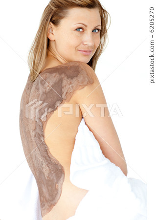 Attractive woman enjoying a mud skin treatment 6205270