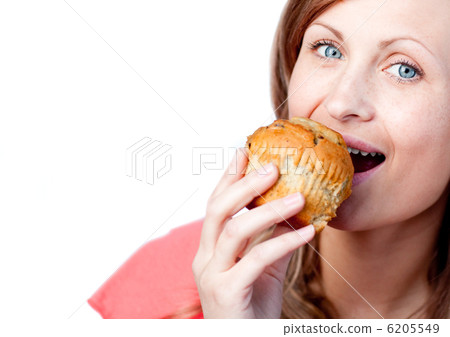 Caucasian woman is eating a muffin Caucasian woman is eating a muffin 6205549