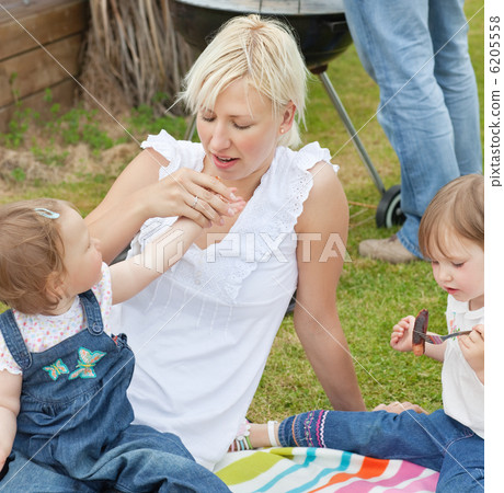 Family eating food in the garden Family eating food in the garden 6205558