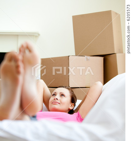 Cute woman having a break between boxes Cute woman having a break between boxes 6205573
