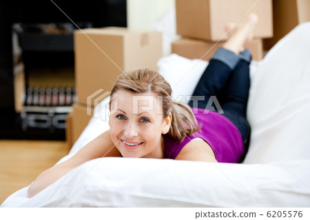 Cheerful woman having a break between boxes Cheerful woman having a break between boxes 6205576